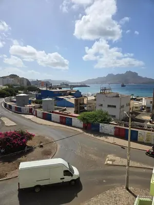 a white van is driving down a street at Cozy 3 Bdr at Praia Da Laginha in Mindelo