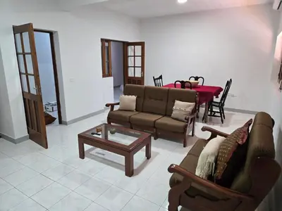 a living room with a couch and a table at Cozy 3 Bdr at Praia Da Laginha in Mindelo