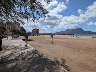 a person standing on a beach near the ocean at Cozy 3 Bdr at Praia Da Laginha in Mindelo