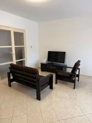 a living room with two chairs and a television at Murdeira V162 A by RPG Group in Beirona