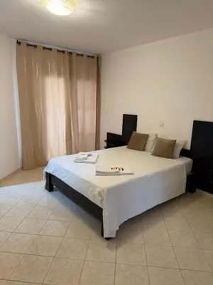 a bedroom with a large white bed in a room at Murdeira V162 A by RPG Group in Beirona