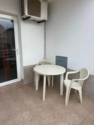 a white table and two chairs and a table and a microwave at Murdeira V162 A by RPG Group in Beirona