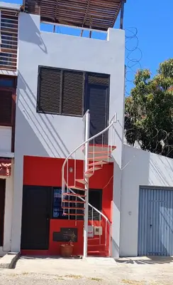 a white building with a red and white staircase at Cozy Apartment in Praia