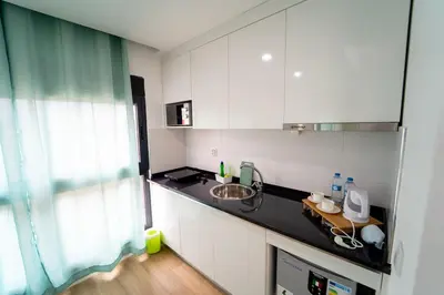a kitchen with white cabinets and a sink at GREEN STUDIO TARRAFAL - Ap 04 in Tarrafal