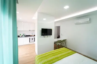 a small room with a bed and a kitchen at GREEN STUDIO TARRAFAL - Ap 04 in Tarrafal