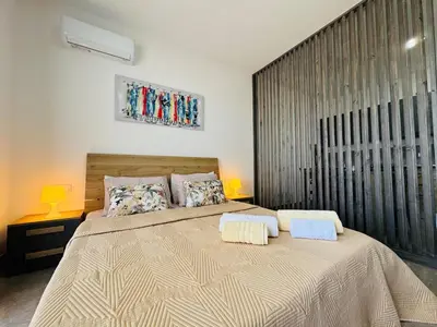 a bedroom with a large bed with two pillows at Estúdio com vista Praça do Presidente in Santa Maria