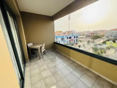 a balcony with a table and a view of a city at Estúdio com vista Praça do Presidente in Santa Maria