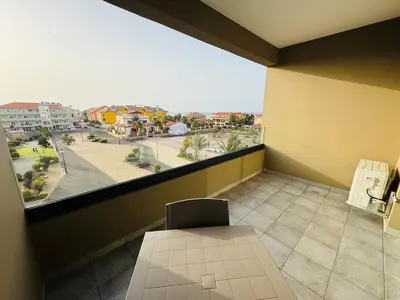 a room with a table and a view of a city at Estúdio com vista Praça do Presidente in Santa Maria