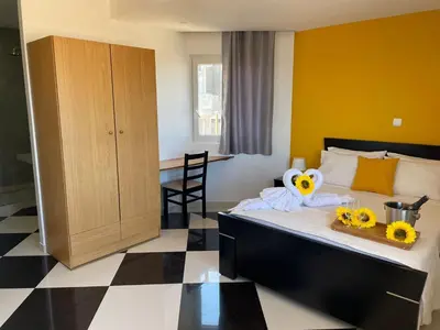 a hotel room with a bed with flowers on it at Residencial Sol Point Art in Ponta do Sol
