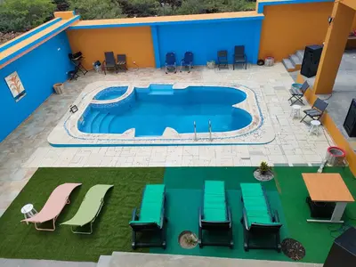 an overhead view of a pool with chairs and tables at Residencial oliveira in Porto Novo