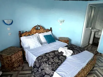 a bedroom with two beds and blue walls at Funco Du Santos in Portela
