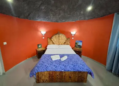 a bedroom with a bed with two towels on it at Funco Du Santos in Portela