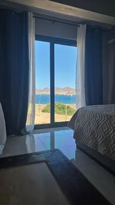 a bedroom with a window with a view of the ocean at Ocean View Studio 4 in Mindelo