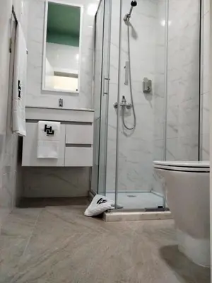 a bathroom with a shower and a sink and a toilet at Urban Hostel Mindelo in Mindelo