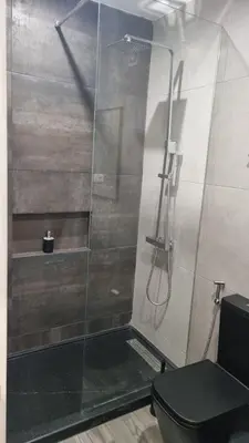 a bathroom with a glass shower with a toilet at Casa Morada in Mindelo