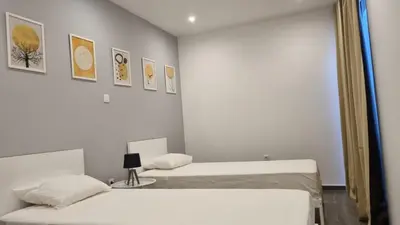 a room with two beds and a mirror at Casa Morada in Mindelo