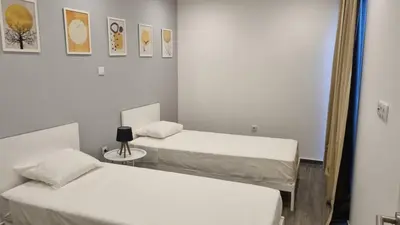 two beds in a small room with a mirror at Casa Morada in Mindelo