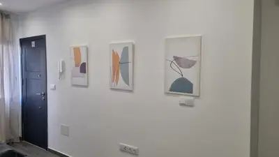 a group of pictures hanging on a wall at Casa Morada in Mindelo