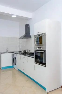 a kitchen with white cabinets and a stove top oven at Mindelo Dias in Mindelo