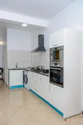 a kitchen with white cabinets and a stove top oven at Mindelo Dias in Mindelo