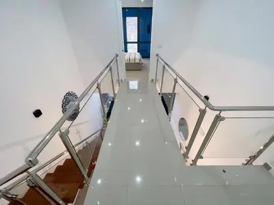 a staircase in a building with a glass railing at Marel Bliss Apartments T3 - Isabel in Mindelo