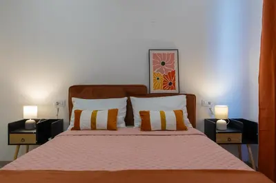 a bedroom with a large bed with two night stands at Marel Bliss Apartments T3 - Isabel in Mindelo