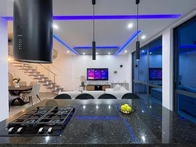 a living room with a kitchen with blue lighting at Marel Bliss Apartments T3 - Isabel in Mindelo
