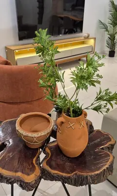a table with a vase on top of a wooden table at kriola Breeze in Praia