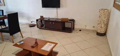a living room with a tv and a table at Apartamento em Condominio Privado in Beirona