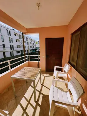 a balcony with a table and two chairs on it at Tropical Breeze Holidays in Santa Maria