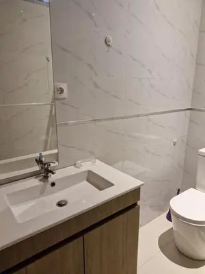 a bathroom with a sink and a toilet and a mirror at Gaudencio Fernandes in Praia
