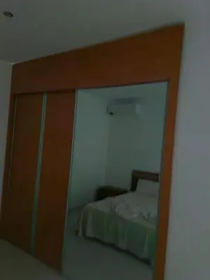 a mirror reflection of a bed in a bedroom at Gaudencio Fernandes in Praia
