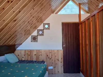 a bedroom with a bed in a wooden ceiling at Paraiso das ilhas in Ribeirão Chiqueiro