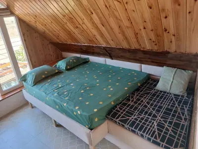 a bed in a room with a wooden ceiling at Paraiso das ilhas in Ribeirão Chiqueiro