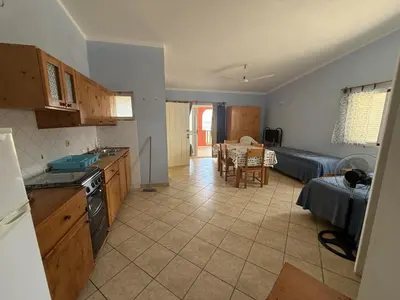 a kitchen and living room with a couch and a table at A Casa do Amor in Vila do Maio
