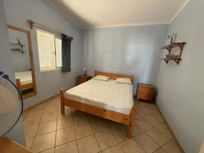 a small bedroom with a bed and a window at A Casa do Amor in Vila do Maio