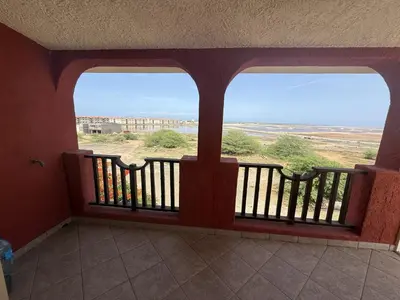 a balcony with two windows and a view of the desert at A Casa do Amor in Vila do Maio