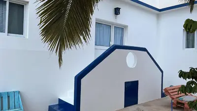 a white house with a blue and white door at Maio Relax in Vila do Maio
