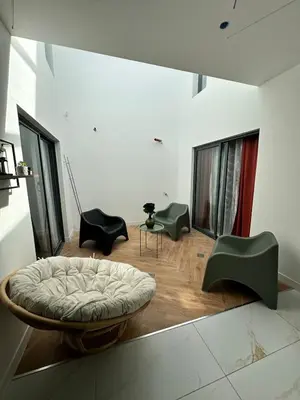 a living room with a bed and some chairs at Belle maison Cosy et Moderne in Praia