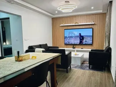 a living room with a flat screen tv on a wall at Tropical Nest in Espargos