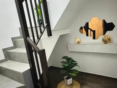 a staircase with a potted plant and a pendant light at Tropical Nest in Espargos