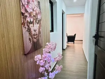 a hallway with a painting of a woman on the wall at Tropical Nest in Espargos