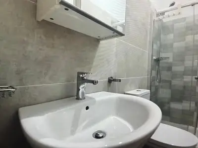 a bathroom with a sink and a shower and a toilet at The Blue Haven in Sal Rei