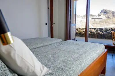 a bedroom with a bed and a window with a view at Casa Vinti9 in Mindelo