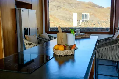 a kitchen with a table with a bowl of fruit on it at Casa Vinti9 in Mindelo