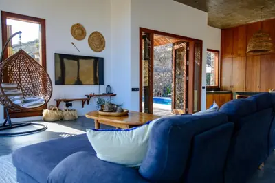 a living room with a blue couch and a table at Casa Vinti9 in Mindelo