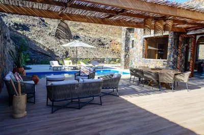 a patio with a table and chairs and a pool at Casa Vinti9 in Mindelo