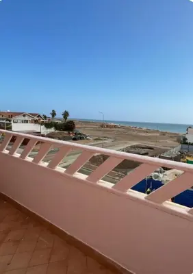 a view of the beach from the balcony of a building at Seaside apartment in Shell Beach in Santa Maria