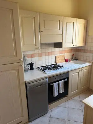 a kitchen with white cabinets and a stove top oven at Seaside apartment in Shell Beach in Santa Maria