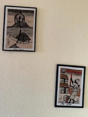 two pictures are hanging on a wall at Seaside apartment in Shell Beach in Santa Maria